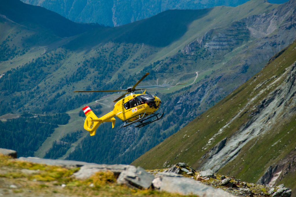 Helicopter flying over mountain ridge